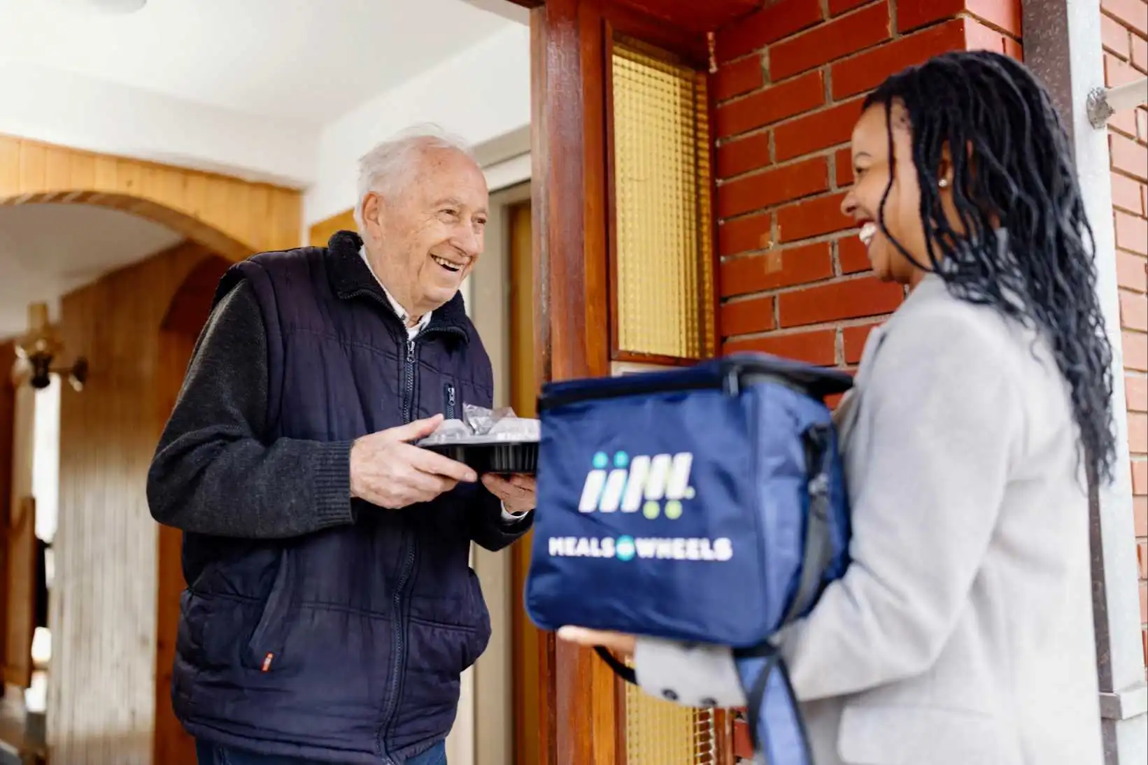 Client-and-Volunteer-delivering-with-Meals-on-Wheels-Bag